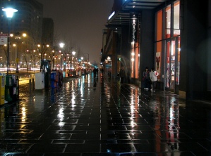 Rainy sidewalk at night
